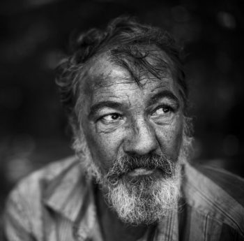 Homeless man on dark background